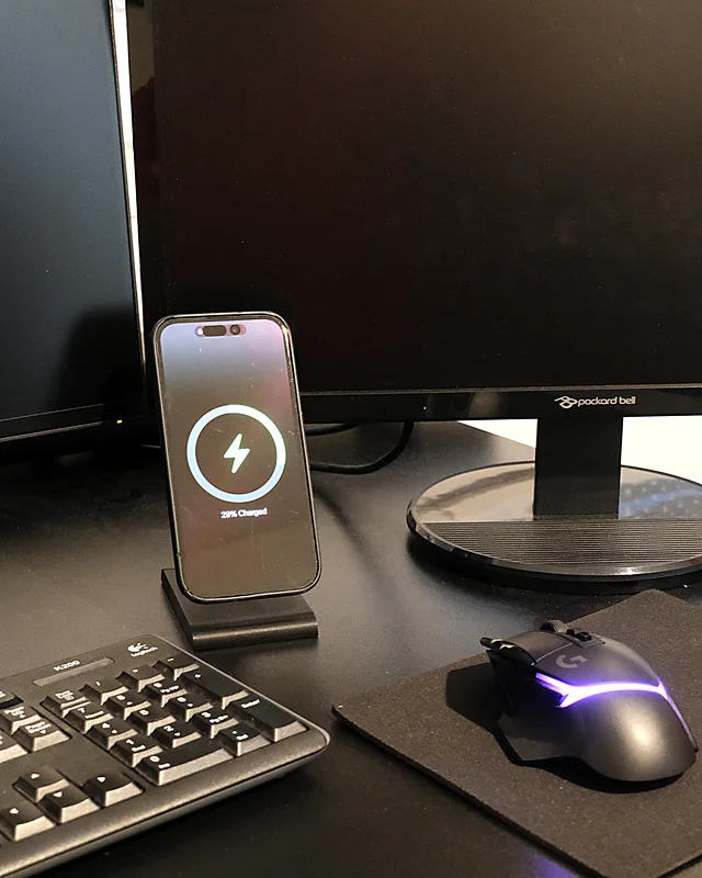 iPhone charging on the HPER, on a desk