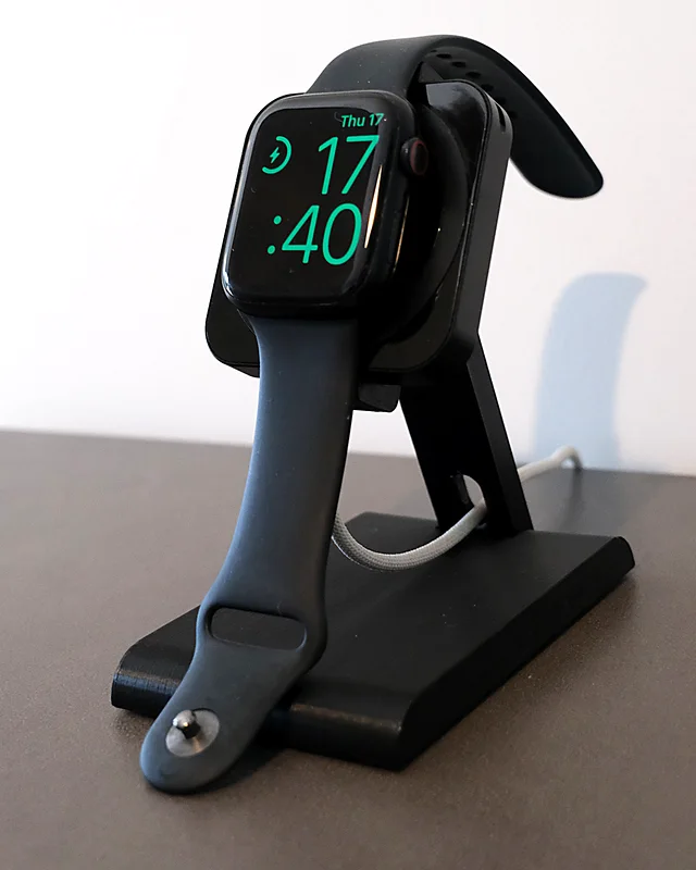Apple Watch charging on the HPER, on a bedside table